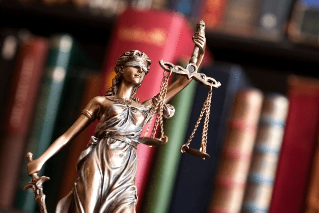 Blindfolded Lady Justice statue with books