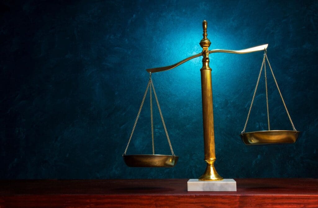 Brass scales balancing over wooden surface