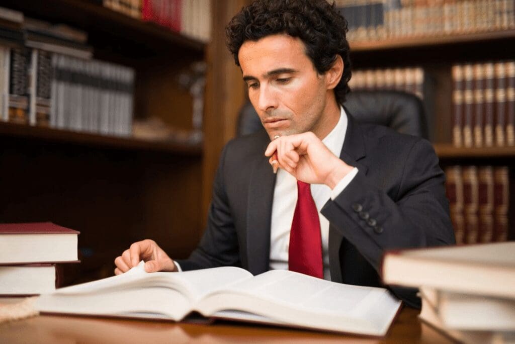 Person reading legal books at desk