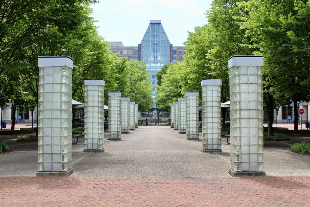 Tree-lined walkway with glass block pillars